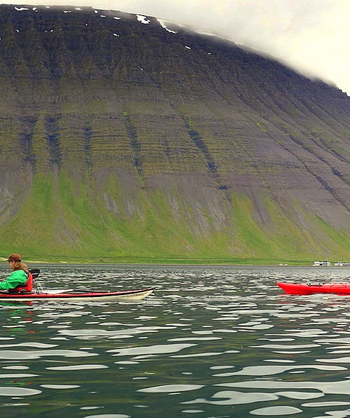 Kayaking by Ísafjörður town in the Westfjords of Iceland