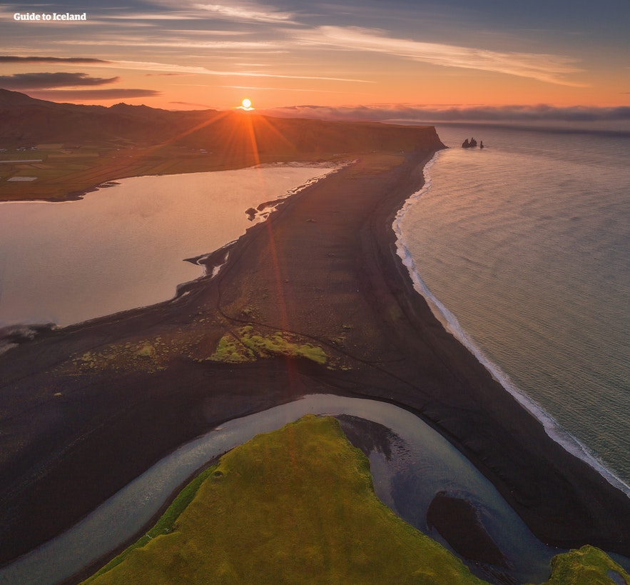 An aerial shot of Reynisfjara black sand beach in South Iceland at golden hour