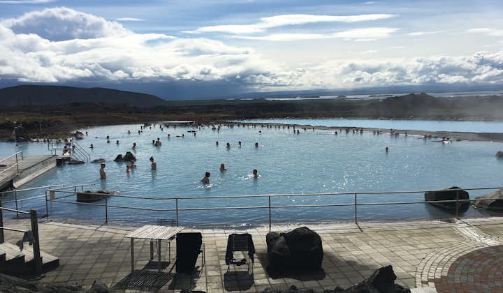 People bathing in a geothermal pool at the Myvatn Nature Baths.