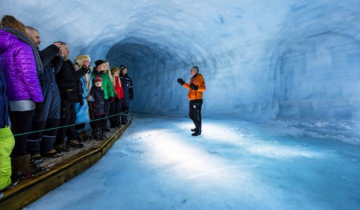 A guide explaining the formation of glaciers to visitors.