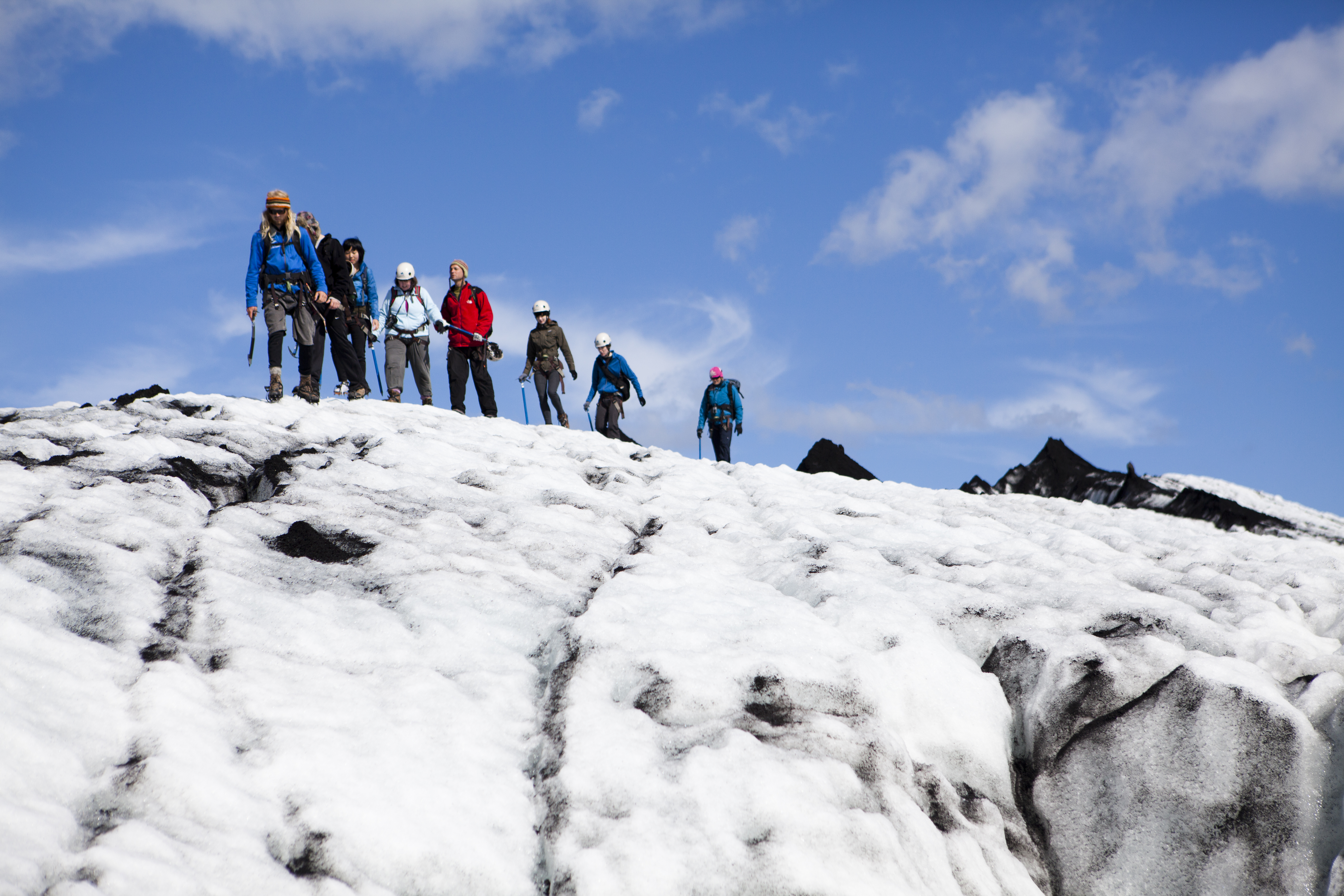 A line of glacier hikers ascend the ice cap in Skaftafell.