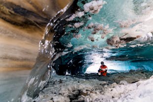 An adventurer exploring an ice cave in Iceland's Langjokull glacier.