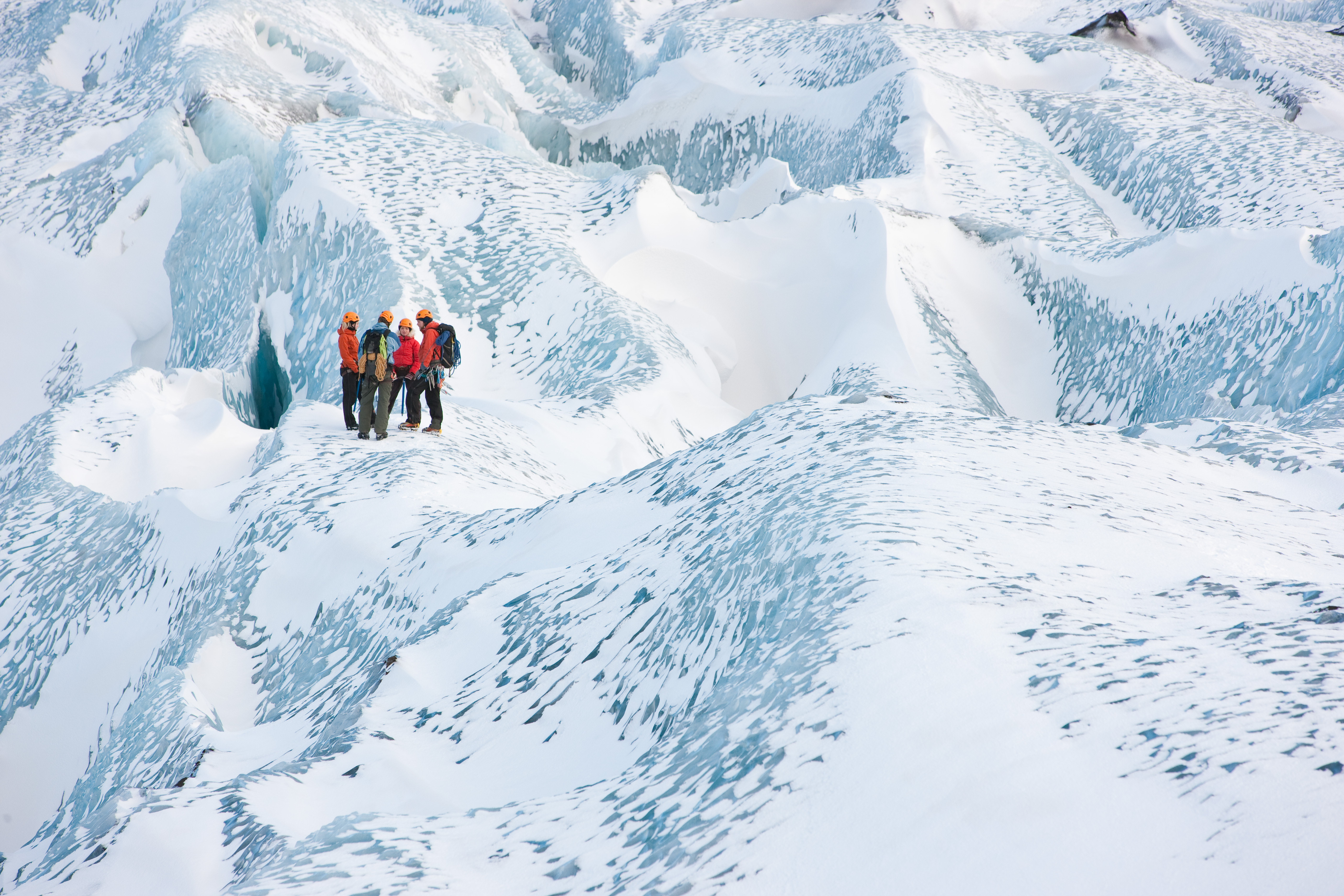 Travelers explore a glacier in Skaftafell.