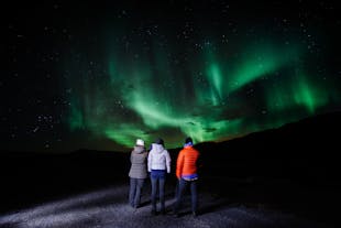 A group of people watching the Northern Lights in Iceland