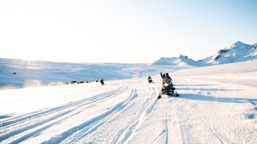 A group of travelers dashing across the mighty glacier of Langjokull in Iceland.