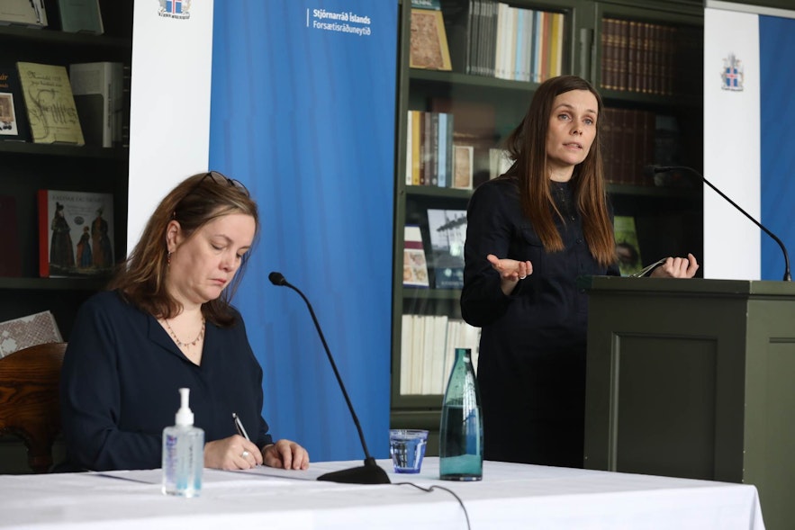 Prime Minister Katrin Jakobsdottir announcing the lifting of restrictions in a press conference.