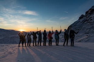A group of people on a glacier at golden hour in Iceland