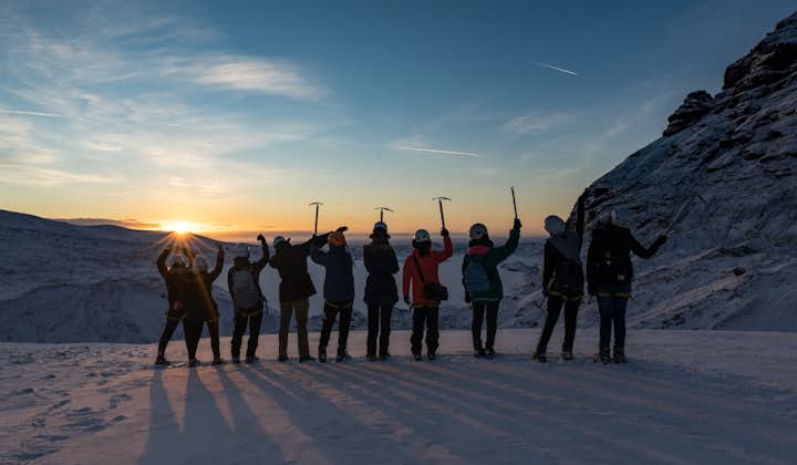A group of people on a glacier at golden hour in Iceland