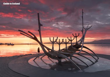 The Sun Voyager Monument pictured on the shoreline of Reykjavik at sunset in summer.