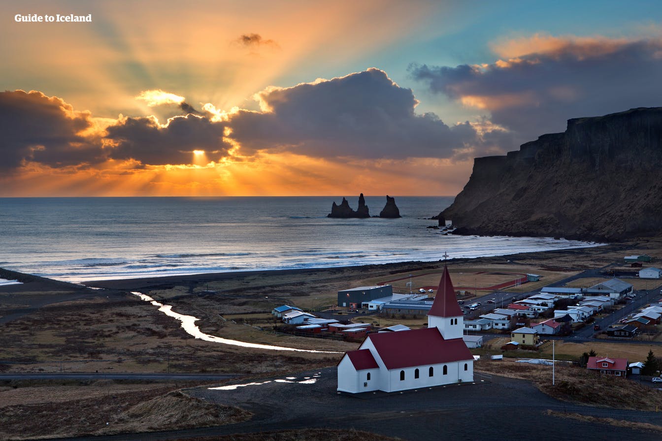 A sunset over the small village of Vik in Southern Iceland in summer.