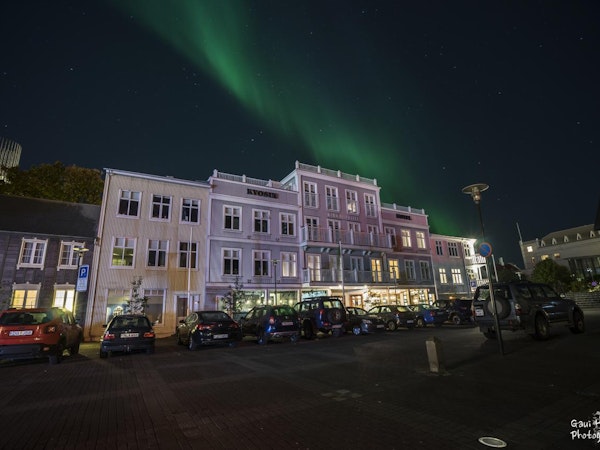 The Northern Lights dance over the Kvosin Downtown Hotel.
