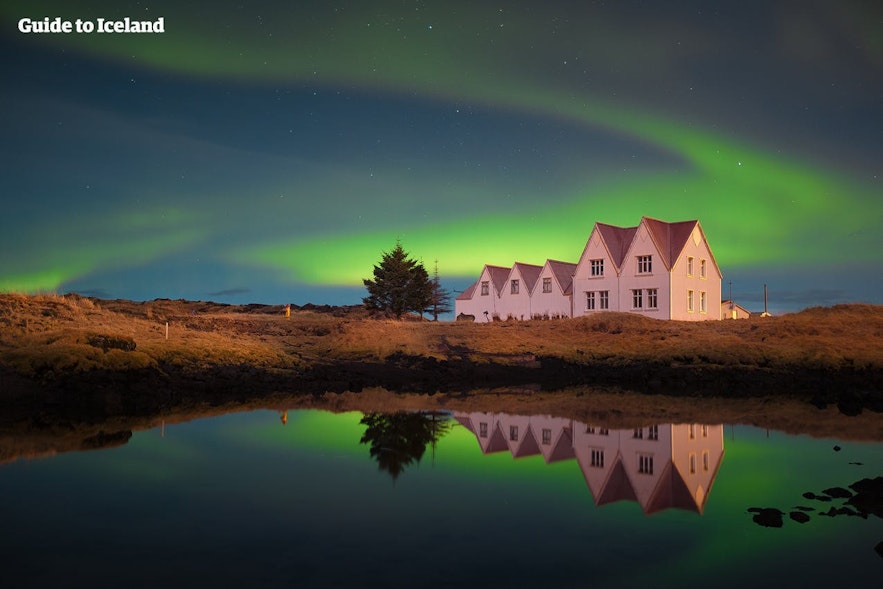 Swirling auroras around an Icelandic farmstead.