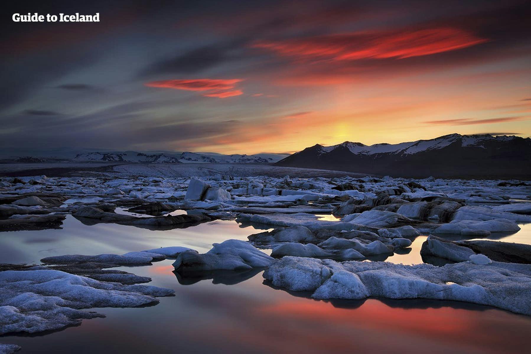 The Jokulsarlon glacier lagoon sits beneath a red sky.