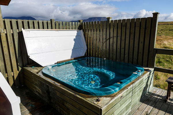 A hot tub sits outside every cabin at Snorrastaðir.