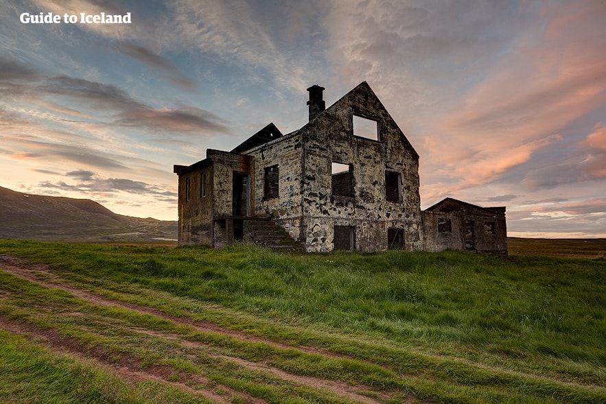 Nature begins to reclaim a building as summer begins in Iceland.