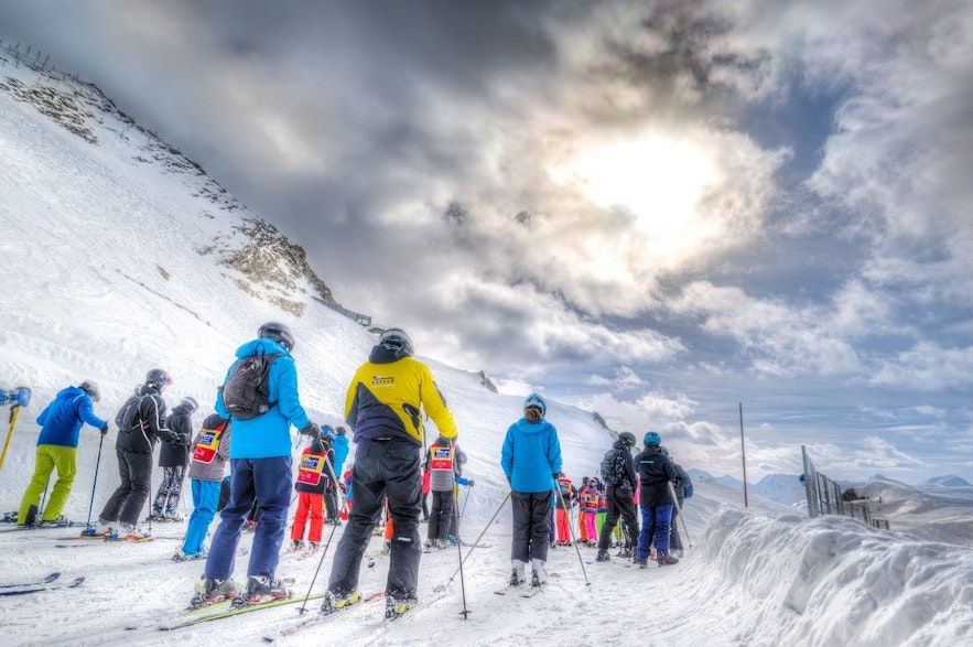 Skiers queue at Blafjoll ski resort.