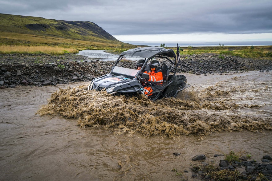A buggy plunges into a muddy river.
