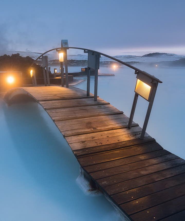 A bridge crosses the azure waters of the Blue Lagoon.