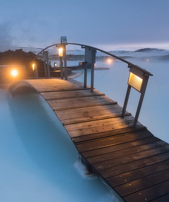 A bridge crosses the azure waters of the Blue Lagoon.