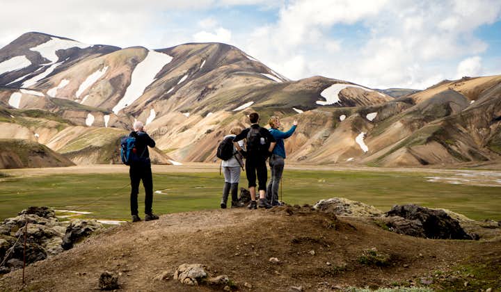 Hikers stand at Landmannalaugar in Iceland.