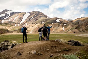 Hikers stand at Landmannalaugar in Iceland.