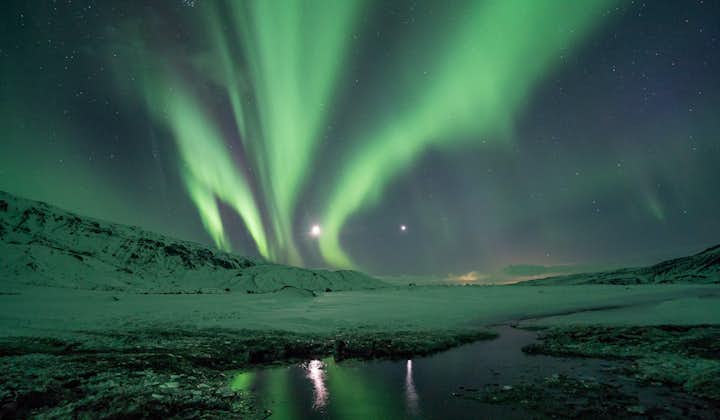 The Northern Lights reflect off a lake in Iceland.