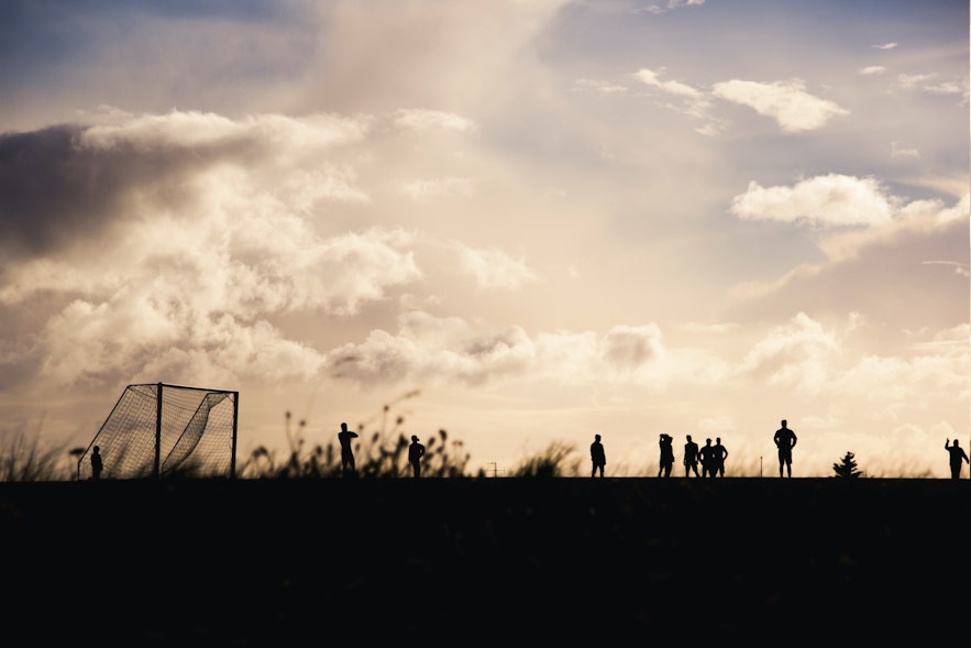 Footballers gather in a field in Iceland.