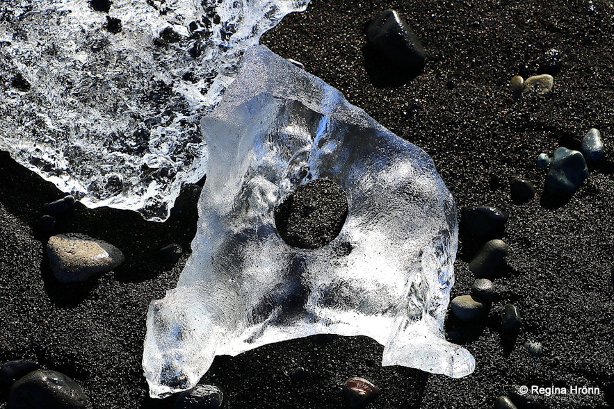 Sparkling ice on the beach by Jökulsárlón