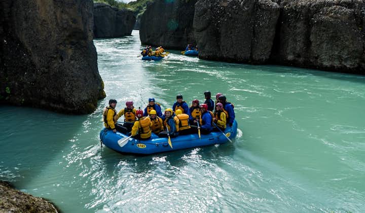 Rafts full of people float along the Hvita river and through the Bruarhlod Canyon.