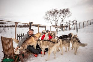 Huskies with their owners in North Iceland during winter.