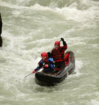 Two people in an inflatable kayak on the white water of the Hvita river.