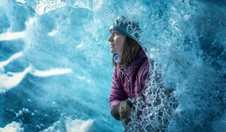 A woman's solo shot inside a blue ice cave.