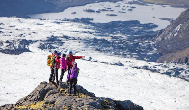 A group of hikers stops to admire the breathtaking views across the Solheimajokull and Myrdalsjokull glaciers.