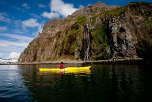 A person in a yellow kayak in the Westfjords.