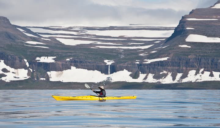 A traveler takes a kayaking adventure in Iceland.