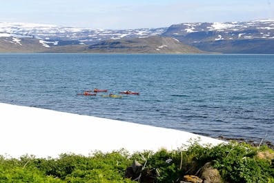 Kayaks in the fjord off the coast of the Hornstrandir Nature Reserve.
