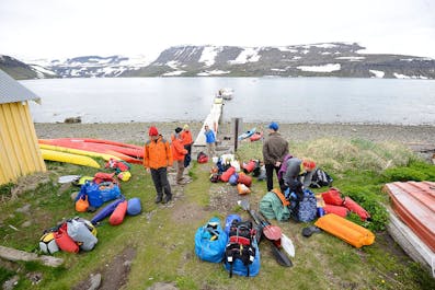 A group of kayakers with their gear in Hornstrandir.