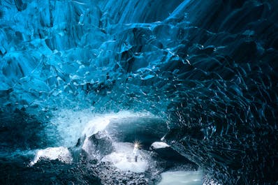 The interior of a crystal-blue ice cave beneath the Vatnajokull glacier.