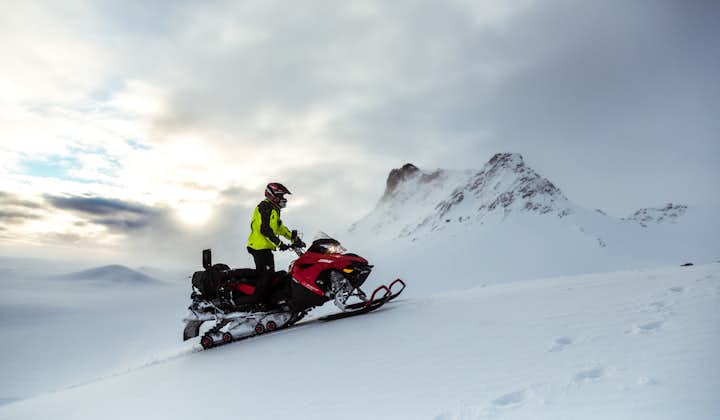 A snowmobiler races across Iceland's slopes.