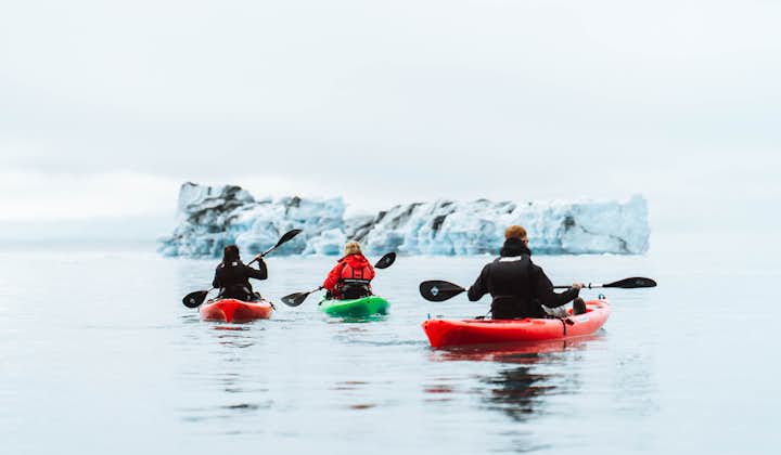 A trio of kayakers travel through Iceland's waters.