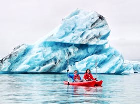 Kayakers navigate the Jokulsarlon glacier lagoon.