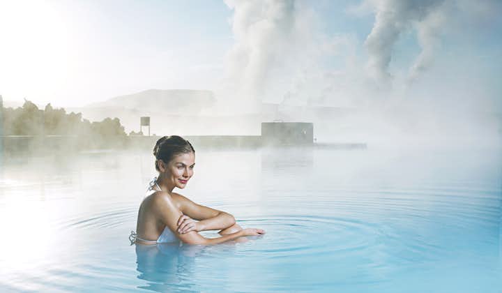 A woman reflects in the azure waters of the Blue Lagoon.