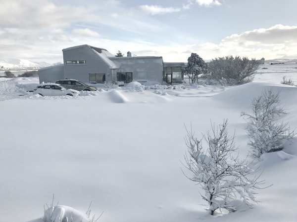 Eyvindarholt Guesthouse in north Iceland, covered in snow.