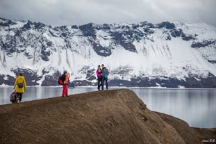 Travelers marvel over the lake at the Askja caldera.