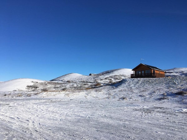 The Hlid Cottage in a winter landscape.