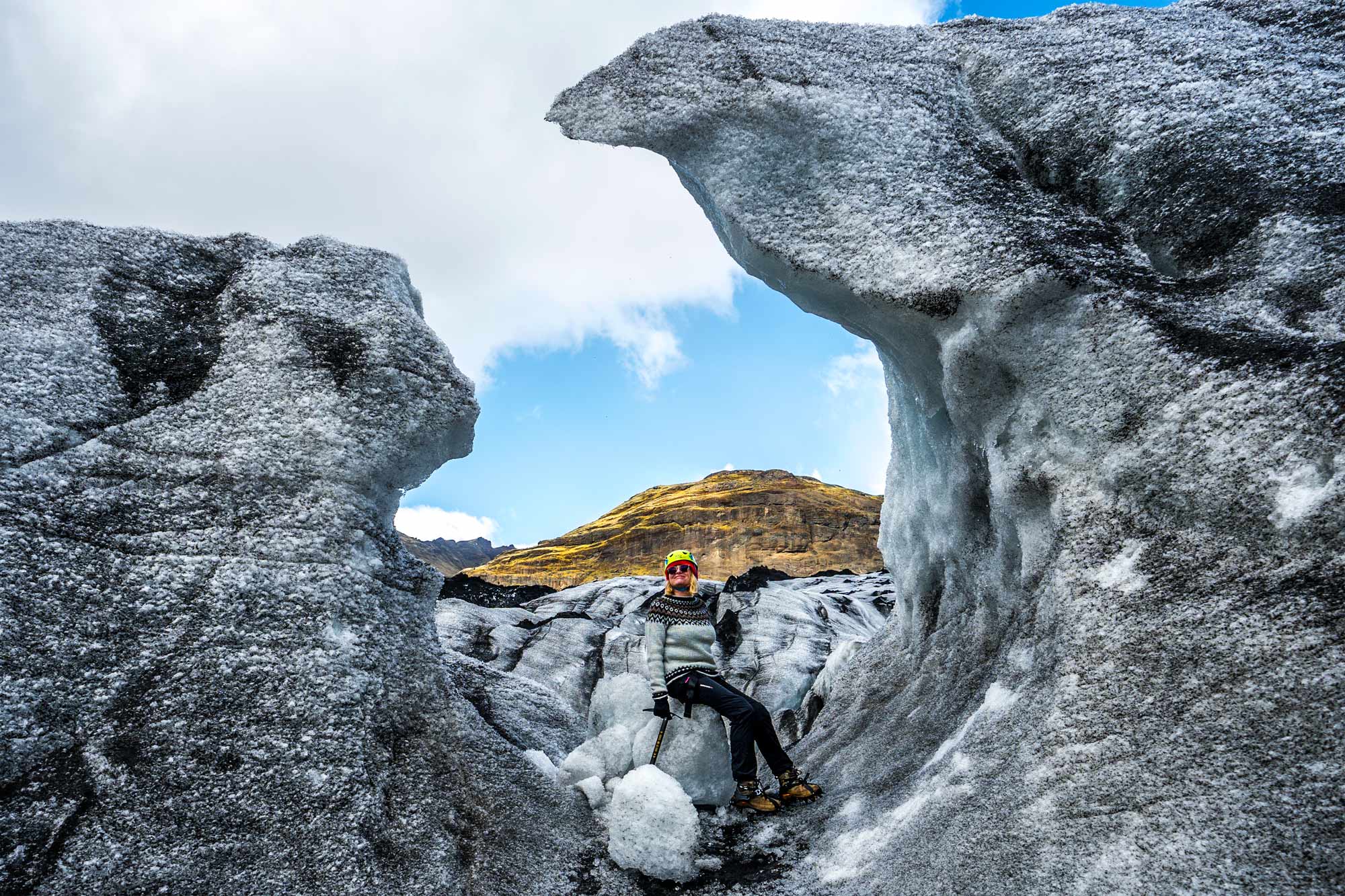 A woman stands on Solheimajokull glacier.