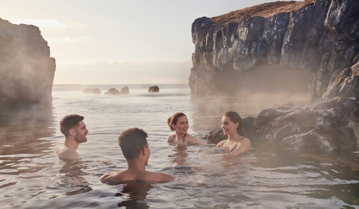 People relax and chat enveloped in the warm water of Iceland's Sky Lagoon.