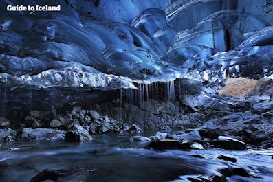 Vivid, deep blue colors adorn the landscape of an ice cave in Iceland in winter.