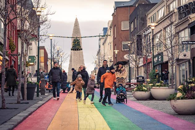 A family walking down the rainbow-painted street of Skolavordustigur, Reykjavik.