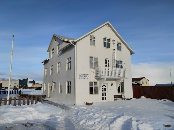 Guesthouse Mikligardur is surrounded by snow in winter.